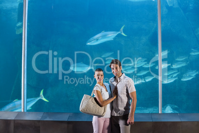 Happy couple beside the fish tank