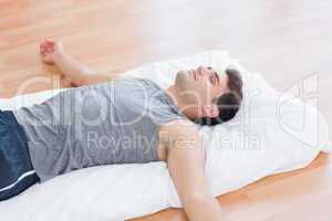 Man relaxing on exercise mat