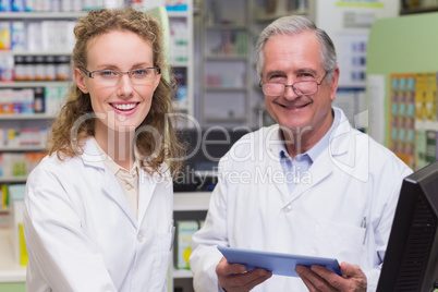 Team of pharmacists smiling at camera