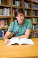 Student sitting in library reading