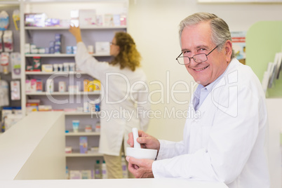 Senior pharmacist mixing a medicine