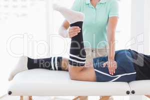 Doctor examining man leg