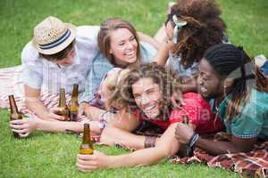 Hipster friends drinking beer and laughing