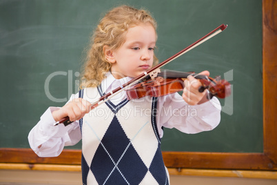 Cute pupil playing the violin