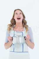 Smiling woman holding saucepan