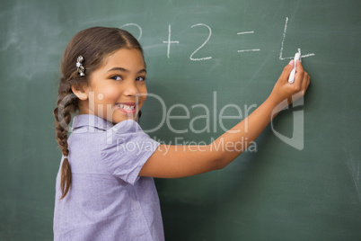 Pupil writing numbers on a blackboard