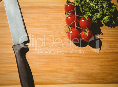 Cherry tomatoes and parsley on chopping board