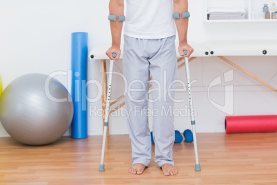 Patient standing with crutch