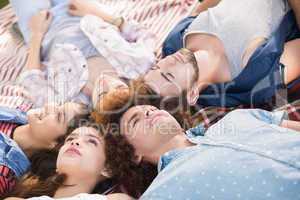 Happy friends lying on blanket