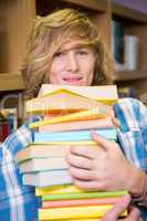 Student smiling at camera in library