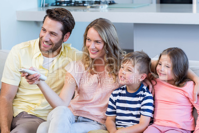 Happy family on the couch watching tv