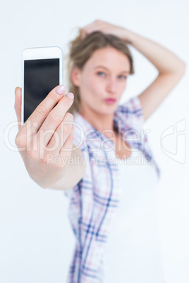 Pretty hipster taking selfie with smartphone