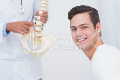 Doctor explaining anatomical spine to his patient