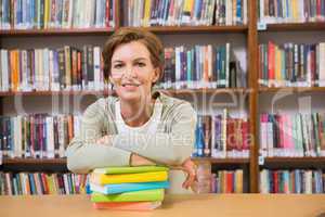 Teacher smiling at camera at library