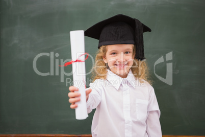 Pupil with graduation hat and holding her diploma
