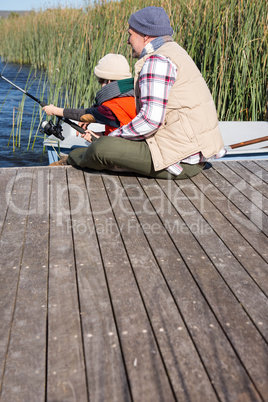 Happy man fishing with his son