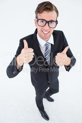 Geeky hipster smiling at camera with thumbs up