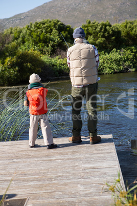 Happy man fishing with his son