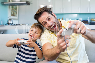 Father and son playing video games together