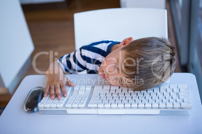 Little boy slipping on keyboard