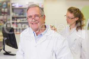 Senior pharmacist smiling at camera