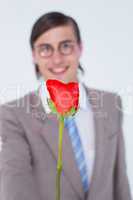 Geeky businessman offering a rose