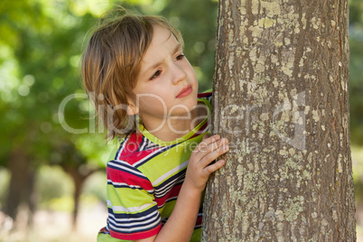 Little boy spying in the park