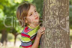 Little boy spying in the park