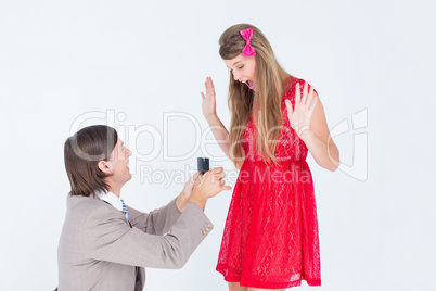 Hipster on bended knee doing a marriage proposal to his girlfrie