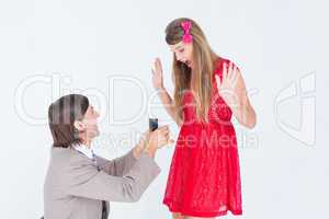 Hipster on bended knee doing a marriage proposal to his girlfrie