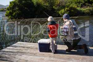 Happy man fishing with his son