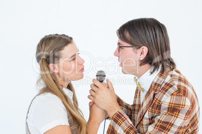 Happy geeky hipsters singing with microphone