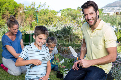 Happy young family gardening together