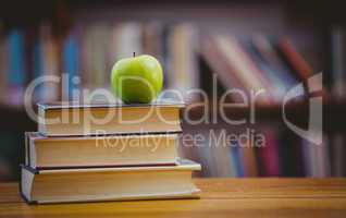 Apple on pile of books