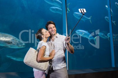 Happy couple using selfie stick