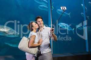 Happy couple using selfie stick