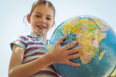 Cute little girl holding globe