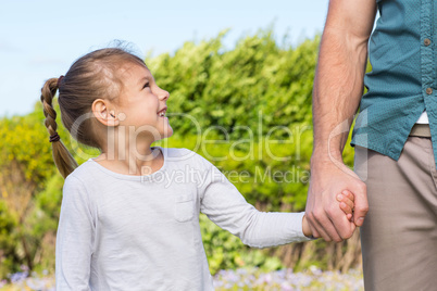 Father and daughter holding hands