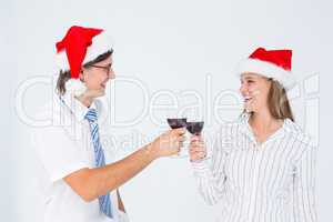 Happy geeky hipster couple drinking red wine