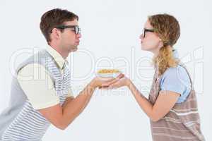Geeky hipster couple holding pasta