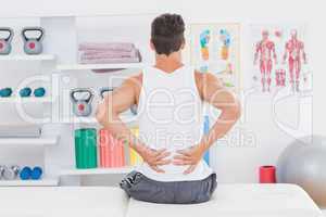 Young man suffering from back pain