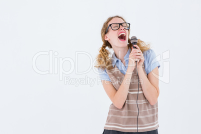 Geeky hipster woman singing into a microphone