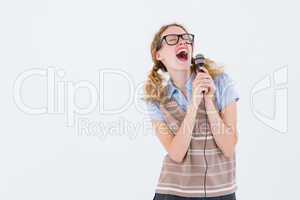 Geeky hipster woman singing into a microphone