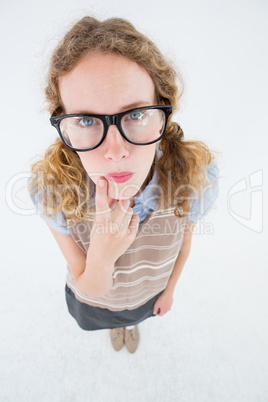 Geeky hipster woman thinking with hand on chin