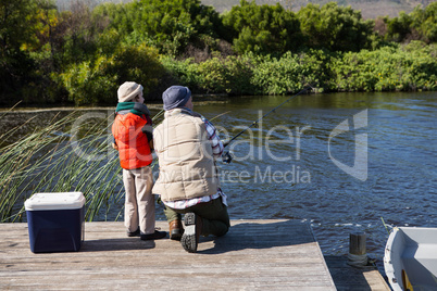 Happy man fishing with his son