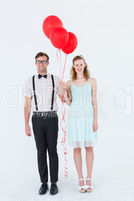 Geeky hipster couple hands in hands looking at camera