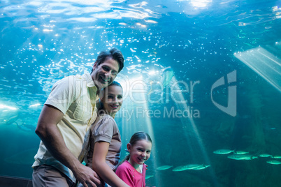 Happy family looking at tank