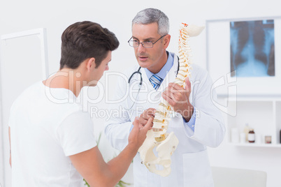 Doctor explaining anatomical spine to his patient