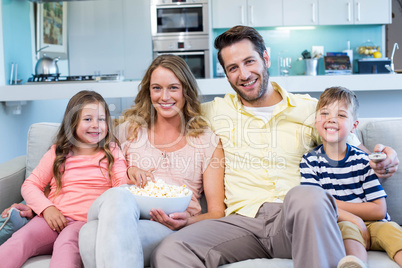 Happy family on the couch watching tv