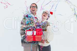 Excited geeky hipster couple looking at confetti